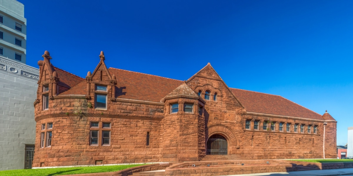 Historic library in New Orleans with restored red clay tile roofing, blending tradition with structural integrity.