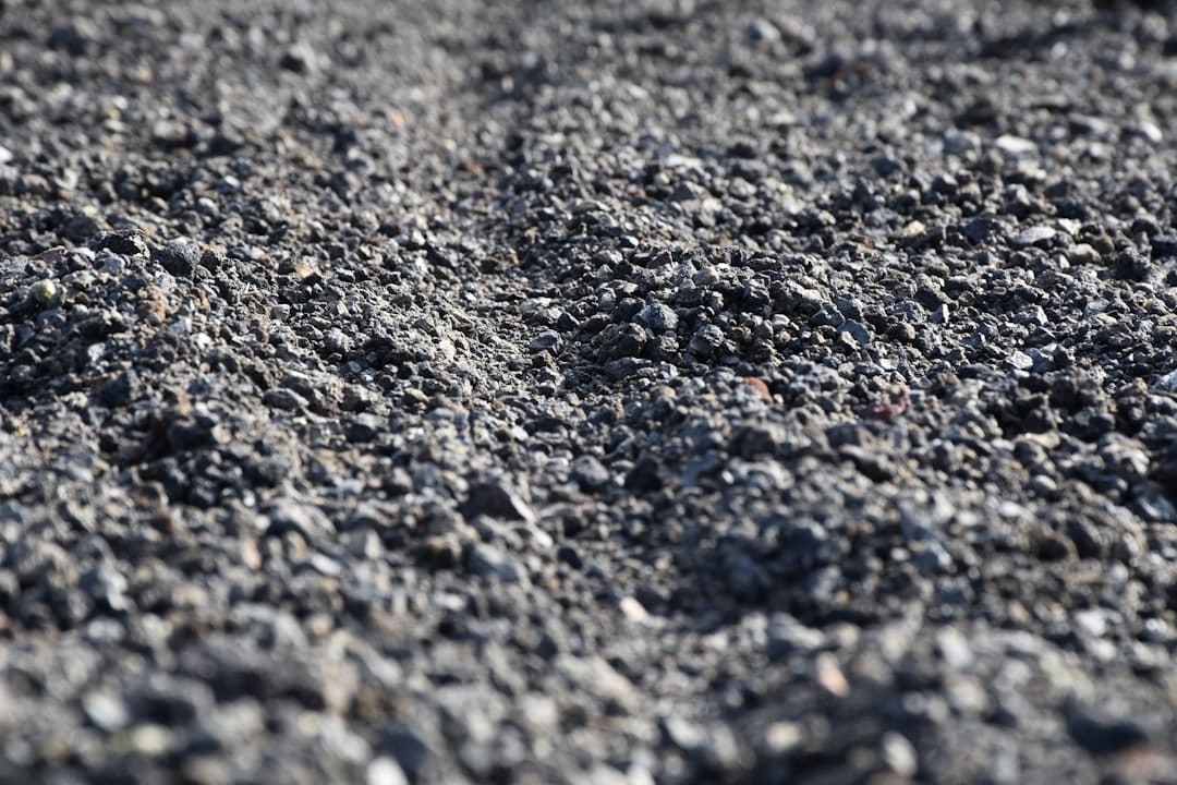 A detailed close-up shot of cracked and curling asphalt roof shingles, showing the kind of damage that needs repair before a hurricane.