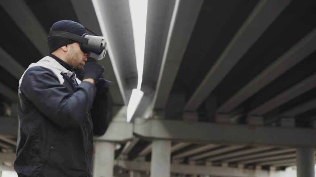 Professional roofer in safety gear carefully examines the shingles on a residential roof, searching for subtle, hidden sig...