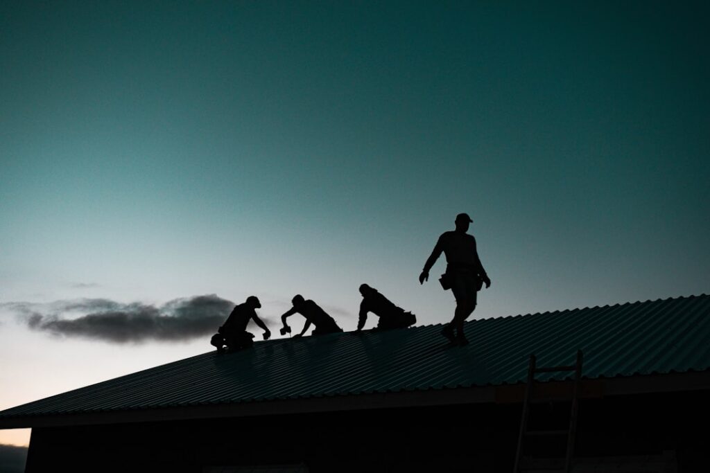 Close-up, professional shot of a roofer meticulously installing the layers of a high-performance roof, with the synthetic ...
