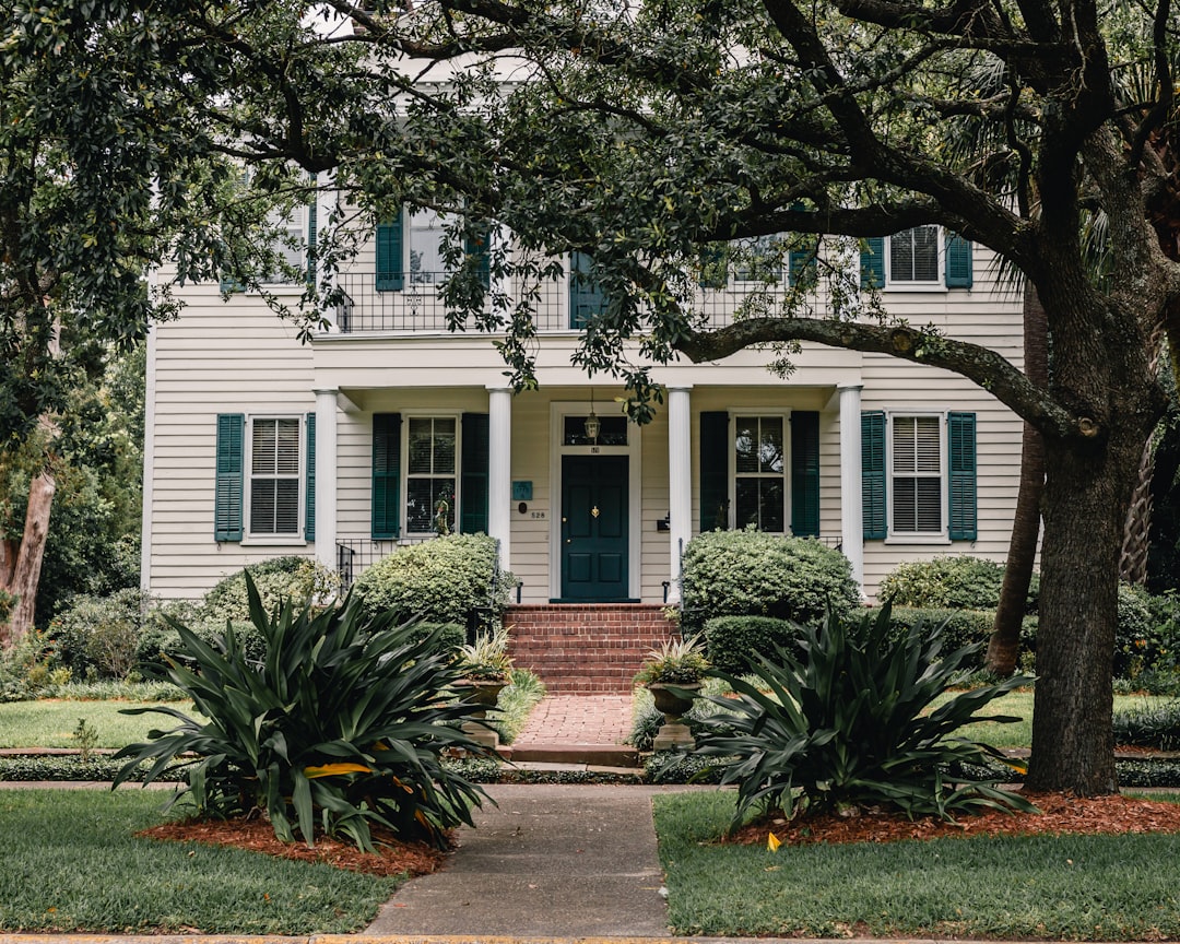 An older asphalt shingle roof on a southern home showing signs of wear and algae from humidity and intense sun, illustrating the need for durable roofing.