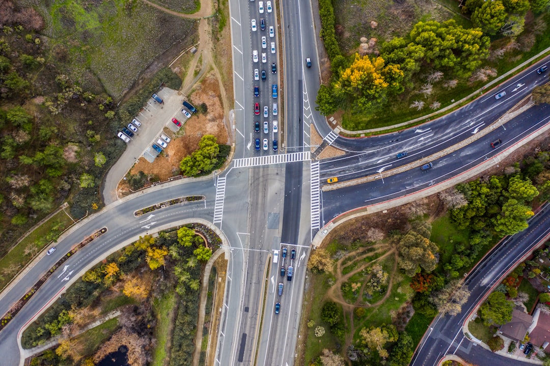 An aerial drone shot of a multi-lane highway showing cars stuck in a massive traffic jam, a visual metaphor for the post-hurricane bottleneck in roofing services.