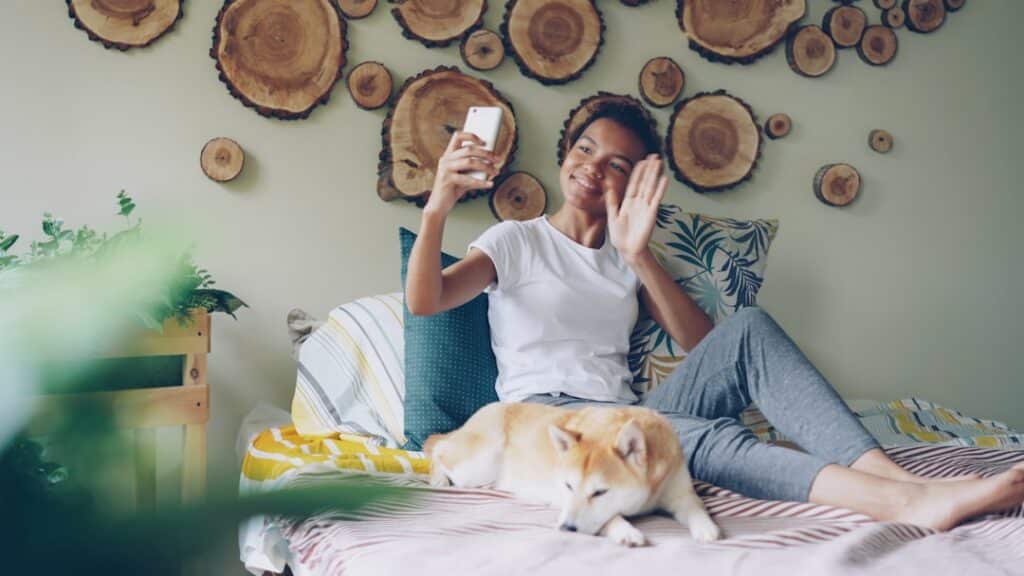 Concerned homeowner sits in a dimly lit room, looking stressed while on the phone, symbolizing the anxiety of trying to fi...