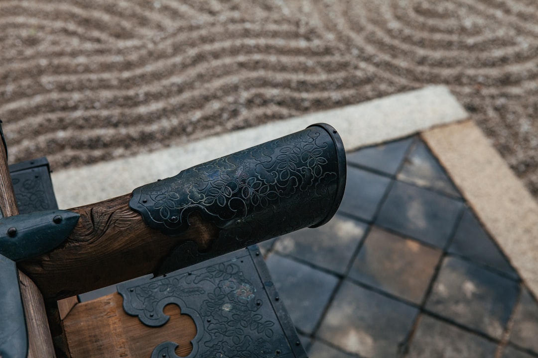 A detailed close-up shot of a roofer's gloved hands meticulously repairing a single damaged asphalt shingle, representing the roof repair option.