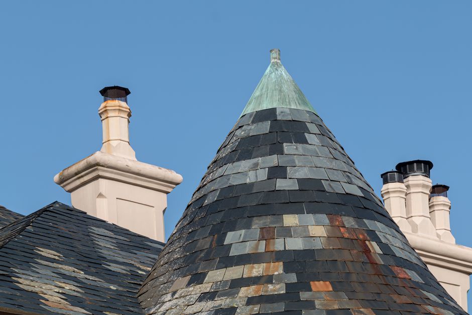 Detailed shot of a classic New Orleans style house, focusing on the unique roofline and architectural features under a bri...