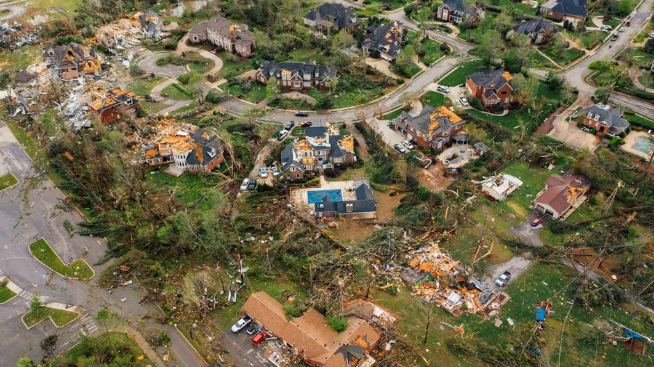 Roof on a home with New Orleans architecture showing visible storm damage under a dramatic, cloudy sky, highlighting the i...